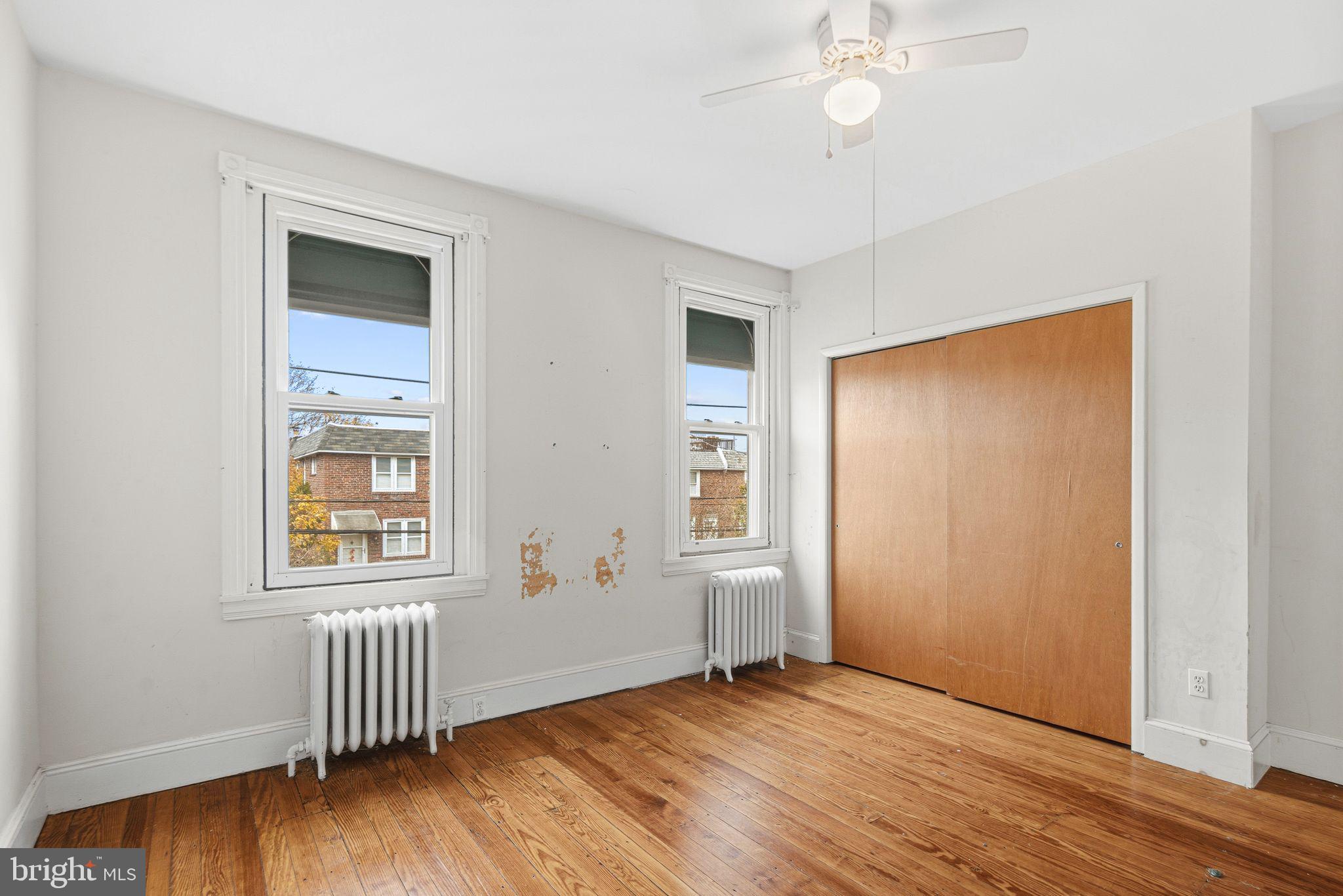 542 Martin Street Philadelphia, PA 19128 - Photo 13 of 16 an empty room with wooden floor and windows
