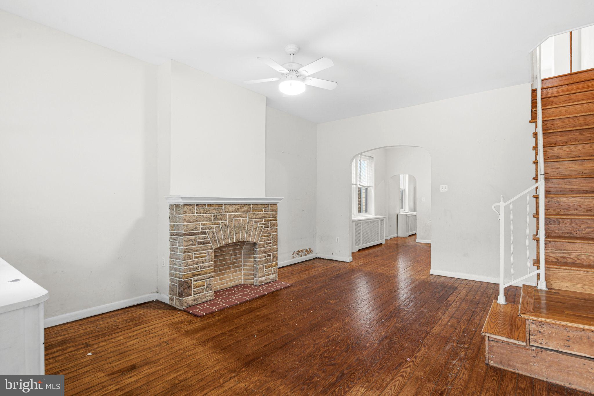 542 Martin Street Philadelphia, PA 19128 - Photo 3 of 16 a view of an empty room with wooden floor and a fireplace