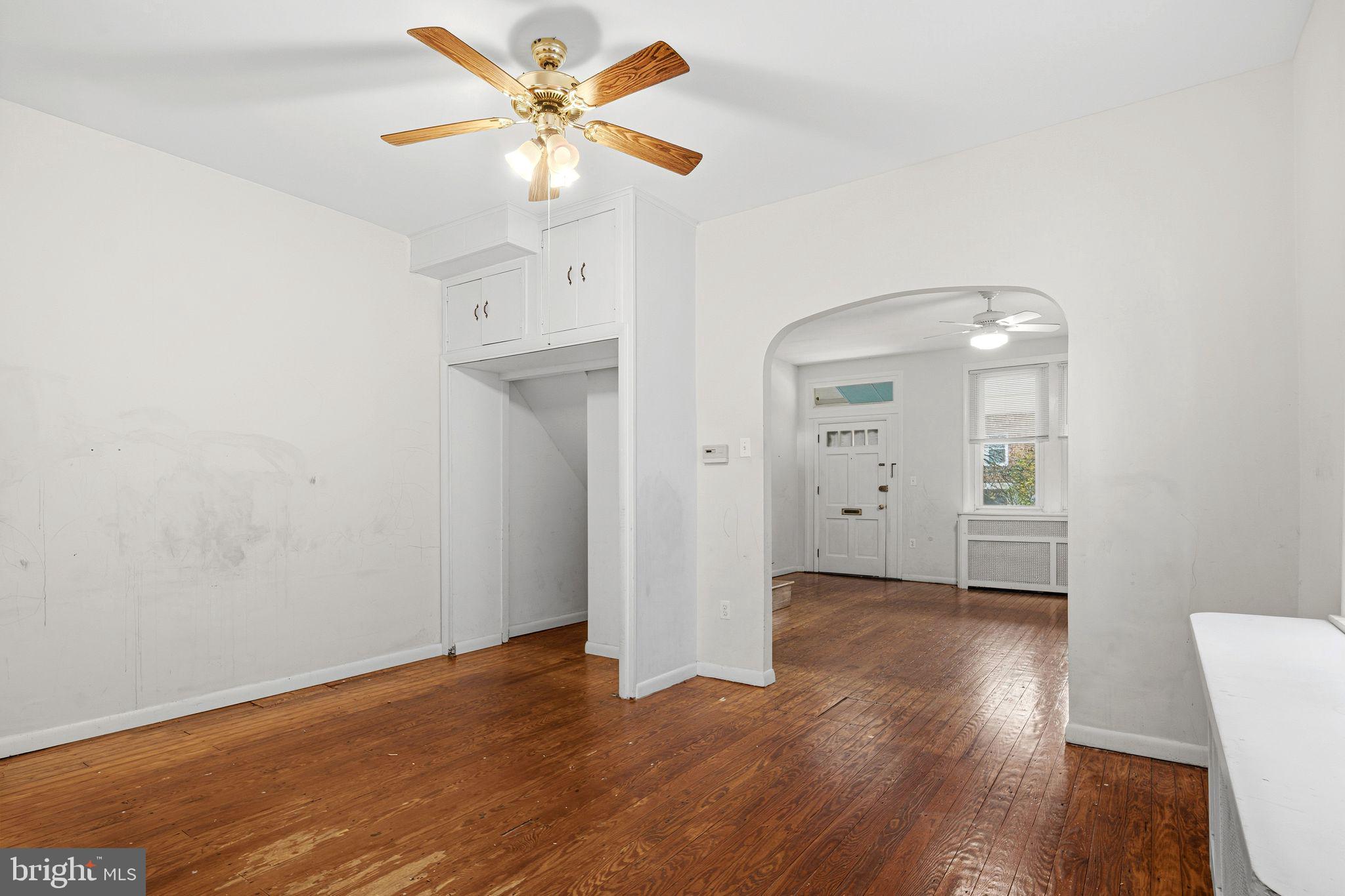 542 Martin Street Philadelphia, PA 19128 - Photo 6 of 16 an empty room with wooden floor and a ceiling fan