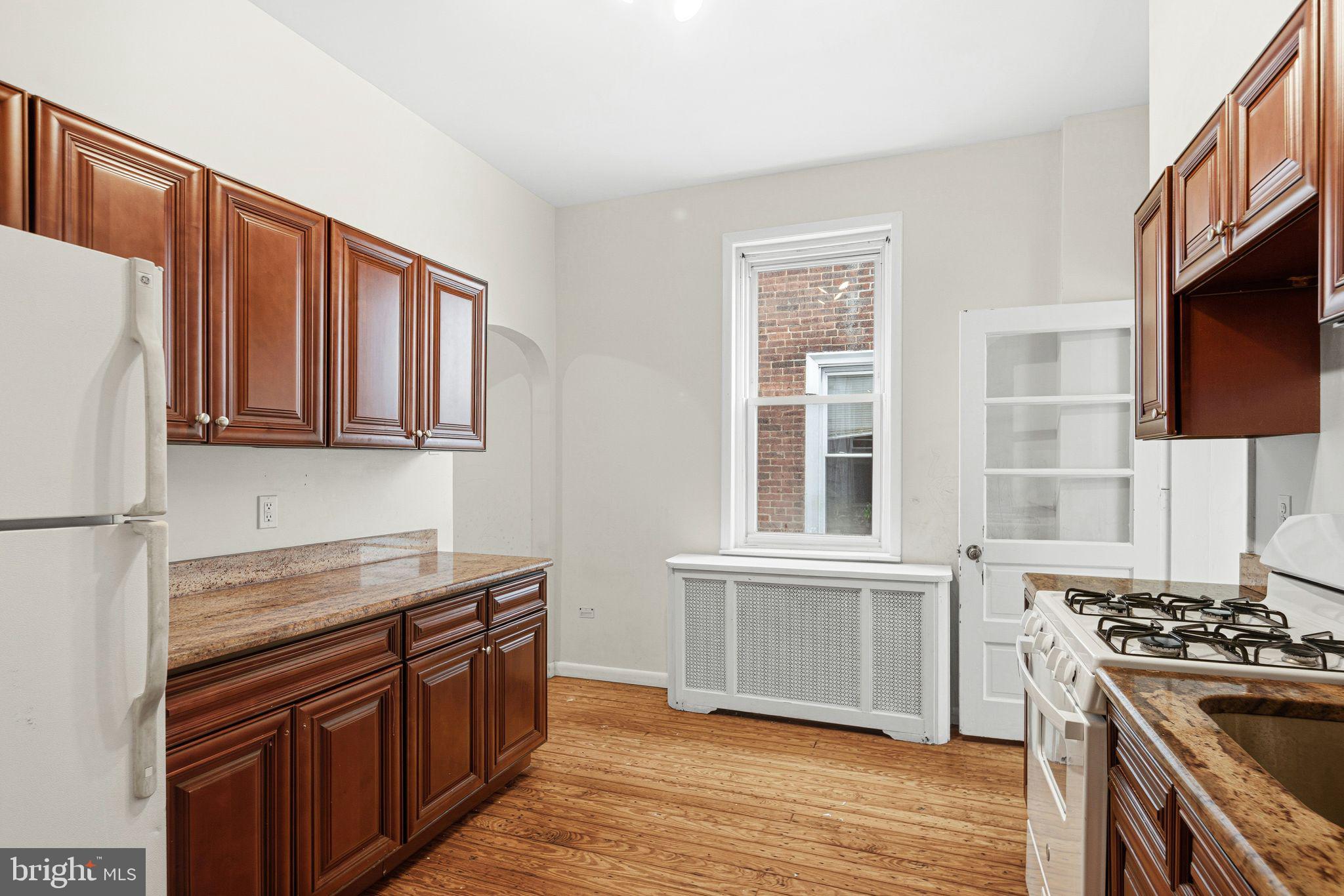 542 Martin Street Philadelphia, PA 19128 - Photo 7 of 16 a kitchen with stainless steel appliances granite countertop a stove a sink and a refrigerator