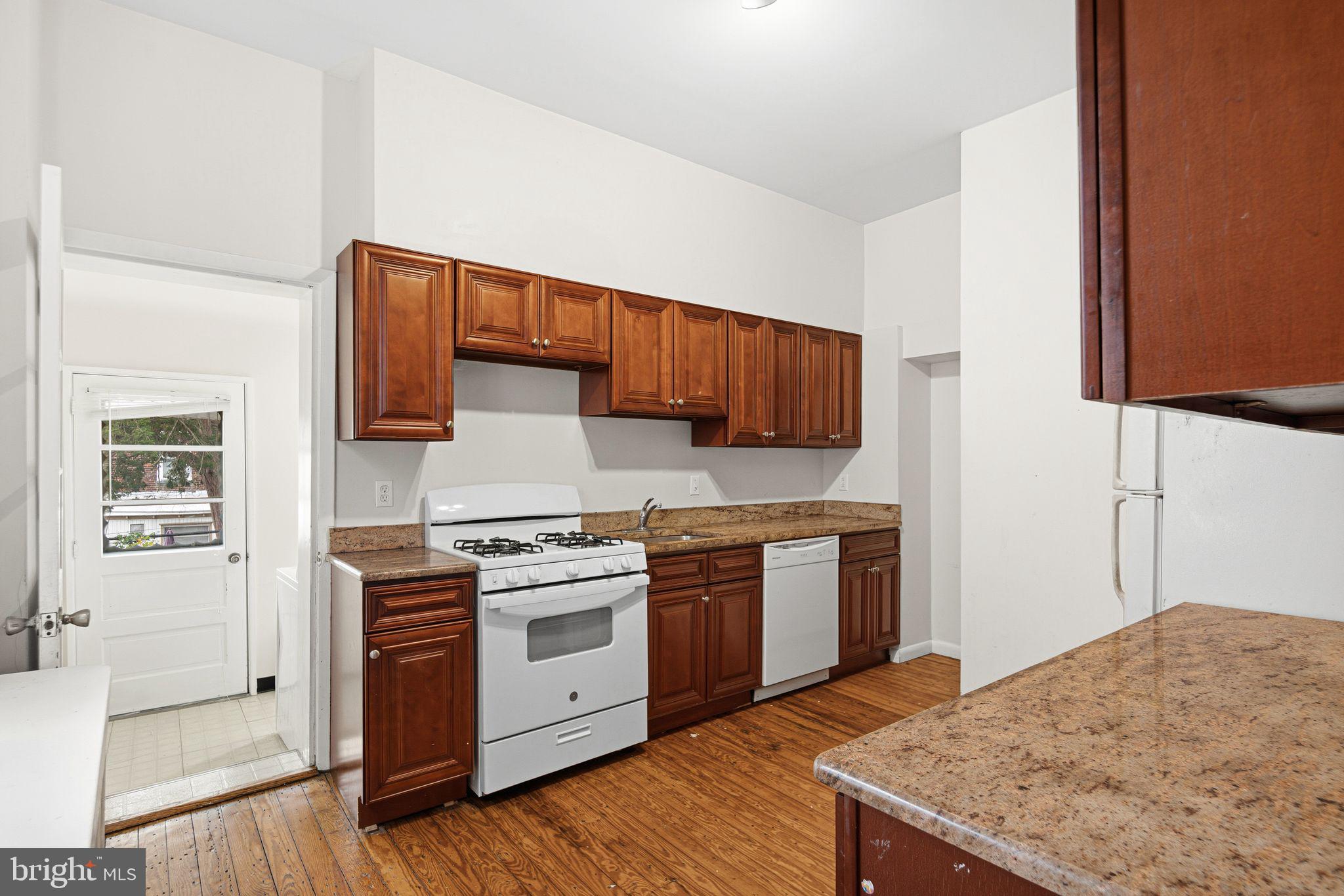 542 Martin Street Philadelphia, PA 19128 - Photo 8 of 16 a kitchen with a stove and a microwave