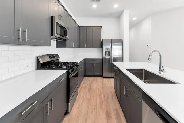 a kitchen with a sink stove and microwave