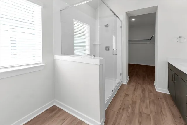 a view of a room with wooden floor and a window