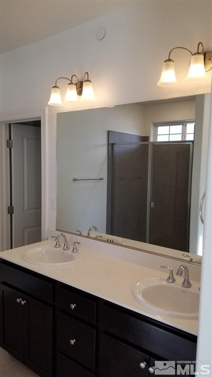 1885 Sea Horse Road, Unit C Reno, NV 89521 - Photo 5 of 9 a bathroom with a sink and a mirror