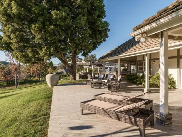 a view of a patio with table and chairs and garden
