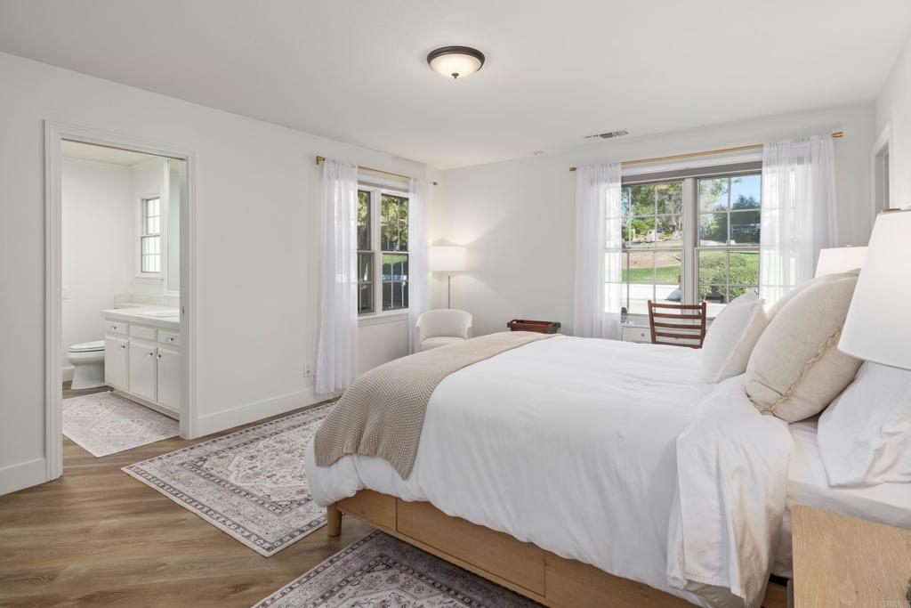 9 Country Glen Road Fallbrook, CA 92028 - Photo 34 of 74 a bedroom with a bed and wooden floor