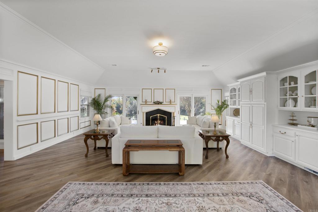9 Country Glen Road Fallbrook, CA 92028 - Photo 4 of 74 a living room with furniture a fireplace and wooden floor