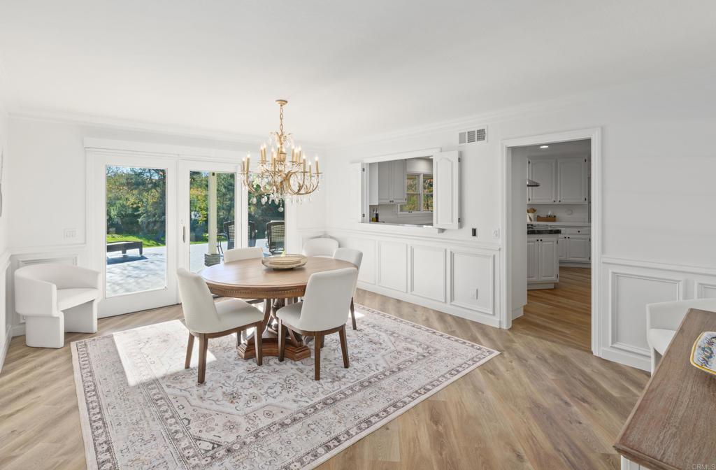 9 Country Glen Road Fallbrook, CA 92028 - Photo 47 of 74 a dining room with furniture a chandelier and wooden floor