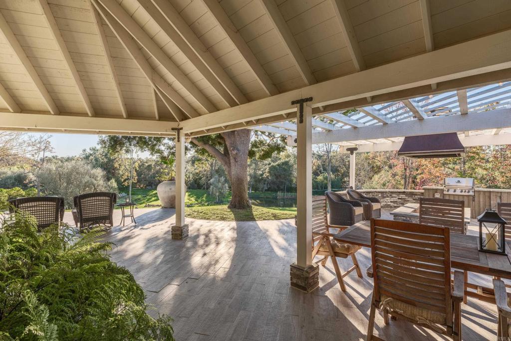 9 Country Glen Road Fallbrook, CA 92028 - Photo 60 of 74 a view of a chairs and table in patio with wooden fence