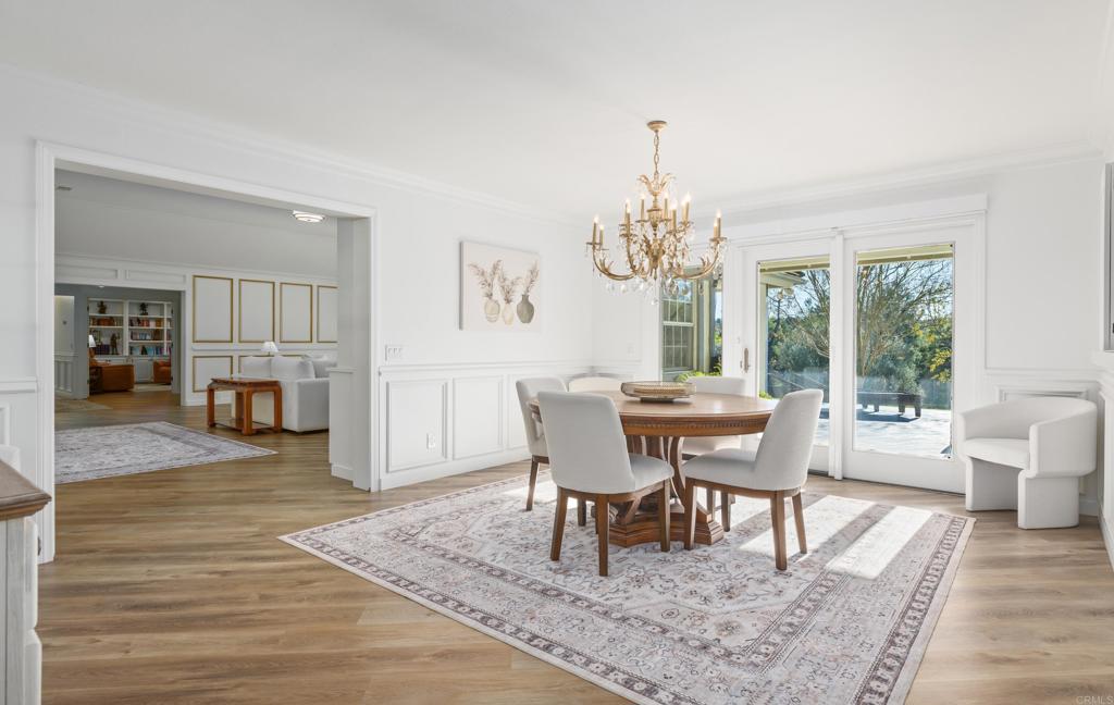 9 Country Glen Road Fallbrook, CA 92028 - Photo 10 of 74 a dining room with furniture a chandelier and wooden floor