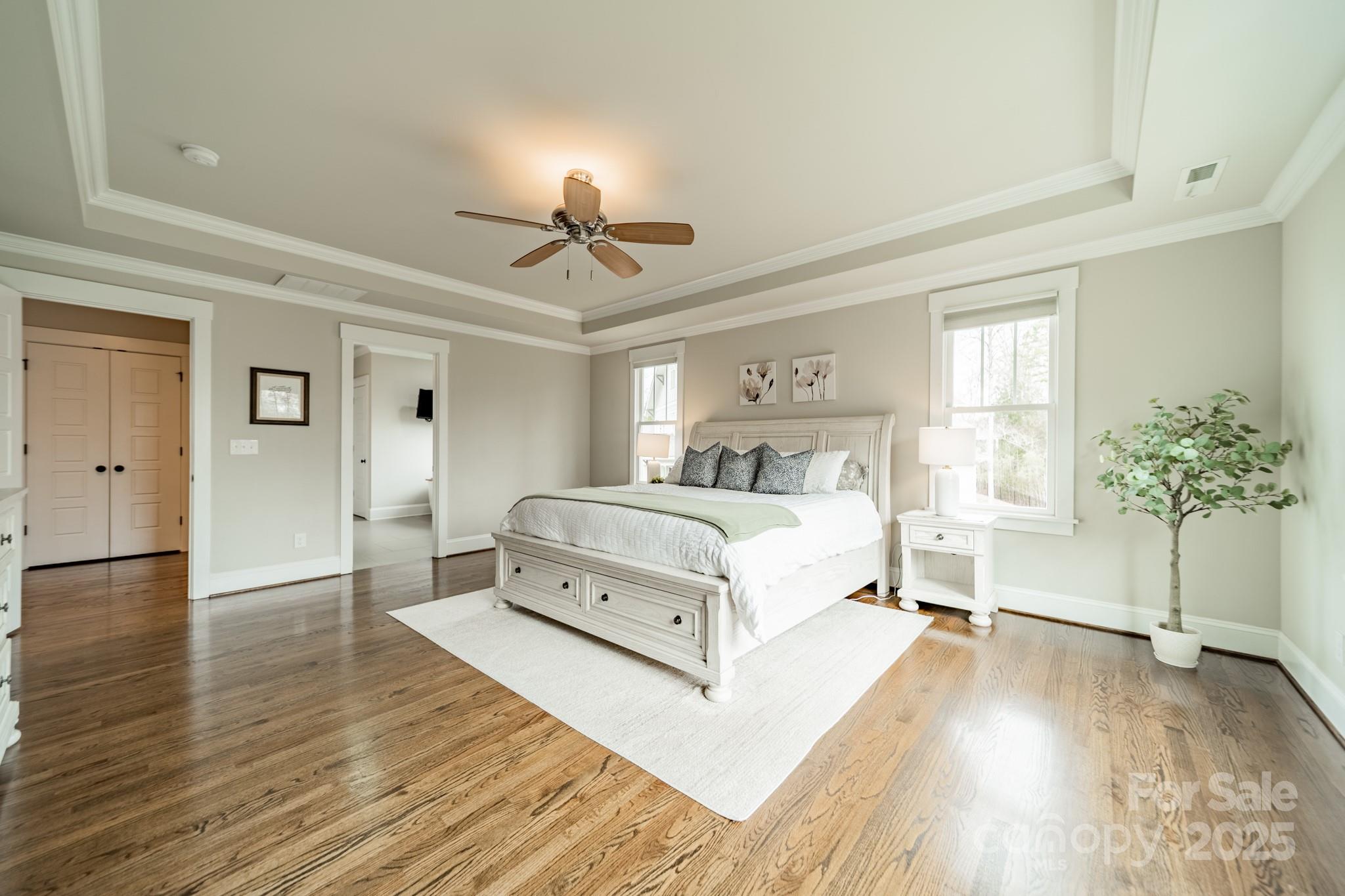 348 Meares Court Fort Mill, SC 29715 - Photo 22 of 47 a bedroom with a large bed and a chandelier