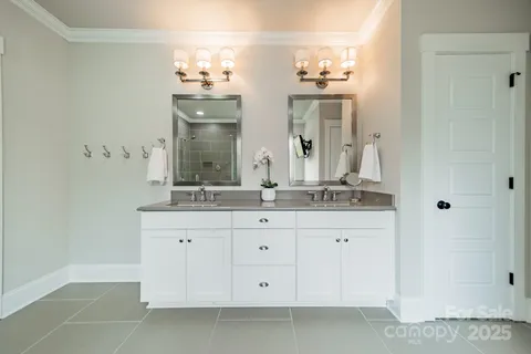 a bathroom with a double vanity sink and a mirror
