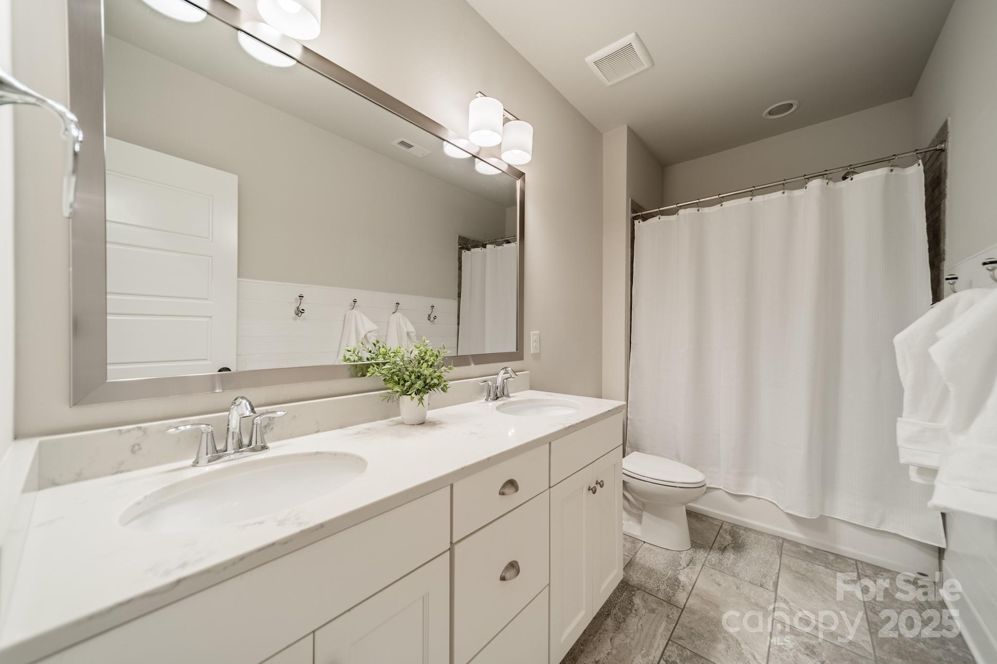 348 Meares Court Fort Mill, SC 29715 - Photo 26 of 47 a bathroom with a double vanity sink toilet and a mirror