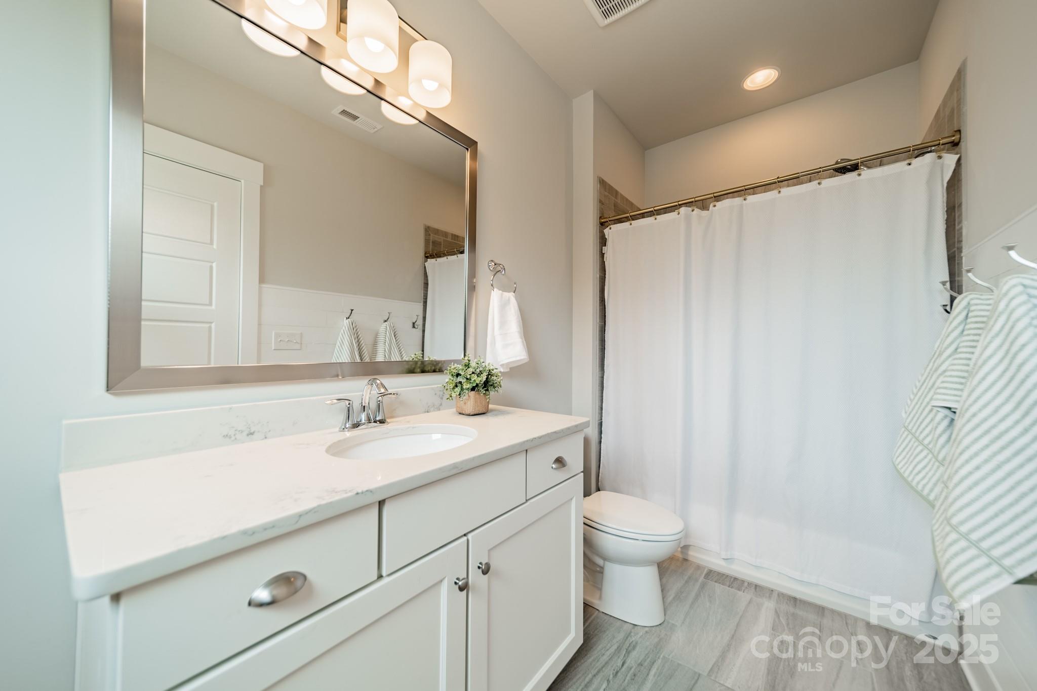 348 Meares Court Fort Mill, SC 29715 - Photo 29 of 47 a bathroom with a granite countertop sink a toilet and a mirror