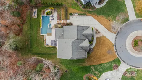 an aerial view of a house with garden space sitting space and swimming pool