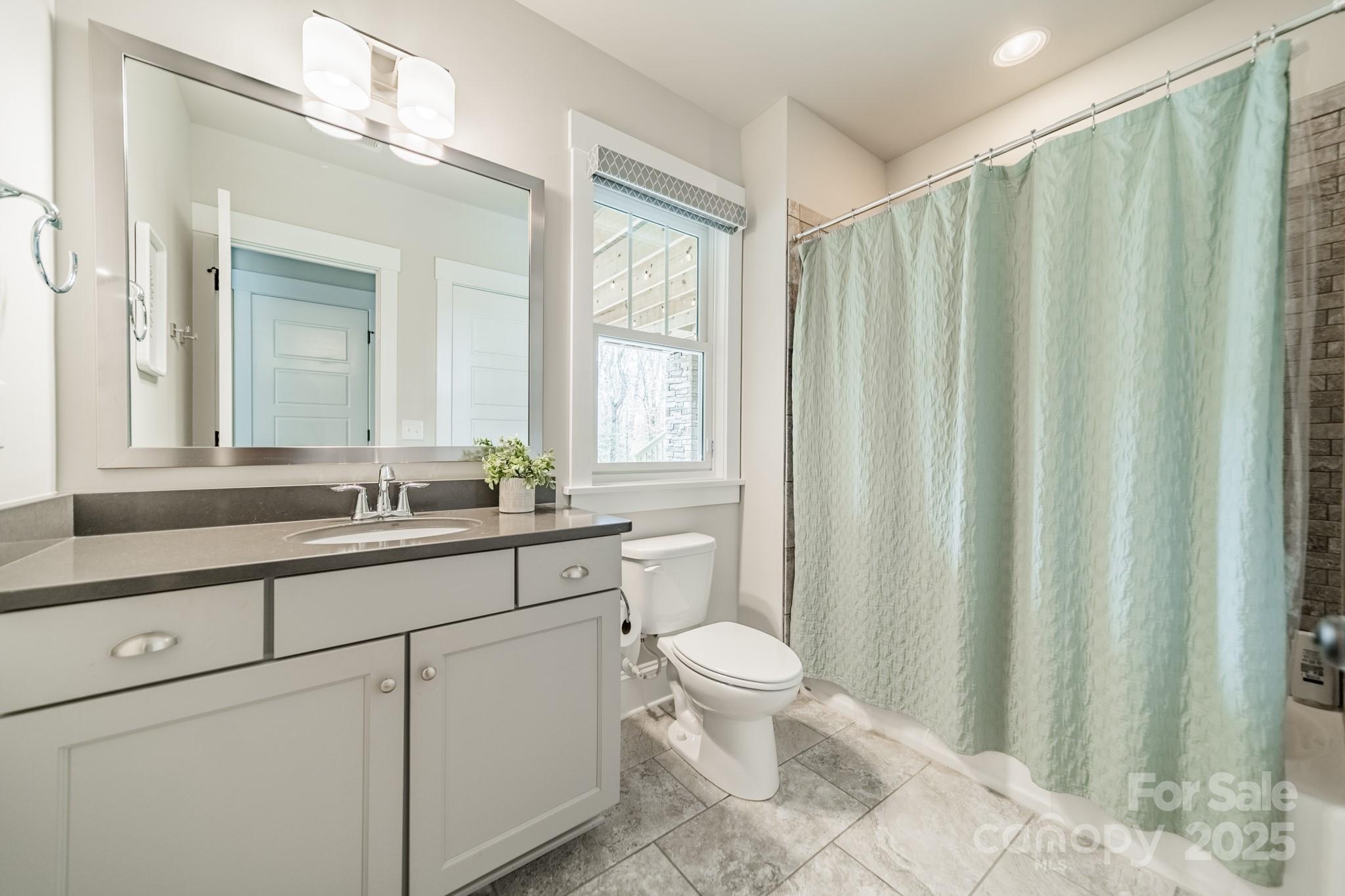 348 Meares Court Fort Mill, SC 29715 - Photo 38 of 47 a bathroom with a toilet a sink and a mirror