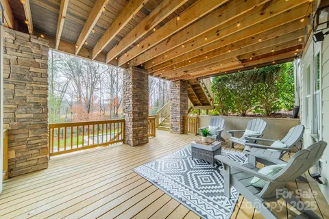a balcony with wooden floor and outdoor seating