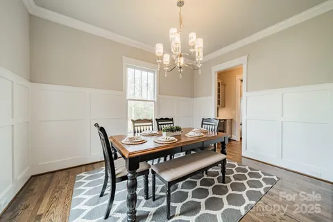 a view of a dining room with furniture and chandelier