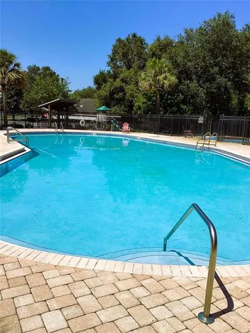 a view of a swimming pool with a yard