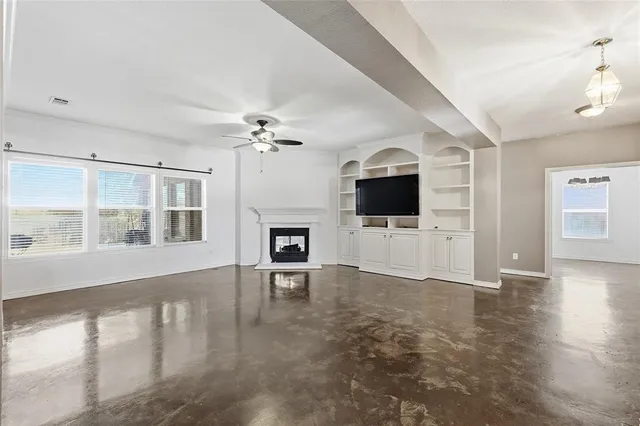 a living room with fireplace furniture and a flat screen tv