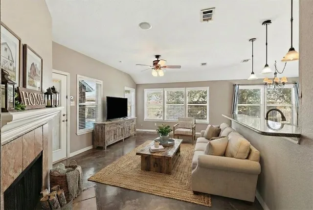a living room with furniture and a fireplace