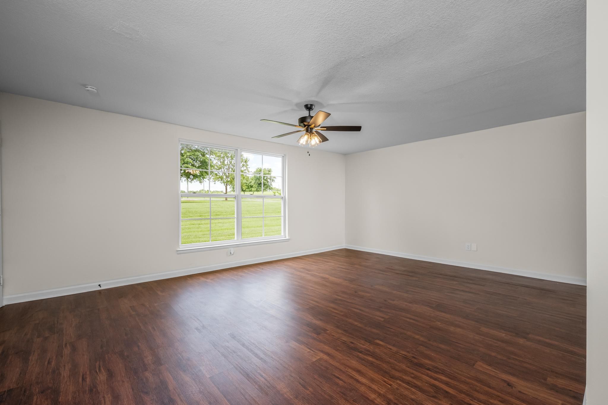 1301 Neelys Bend Road, Unit 30 Madison, TN 37115 - Photo 2 of 15 an empty room with wooden floor chandelier fan and windows