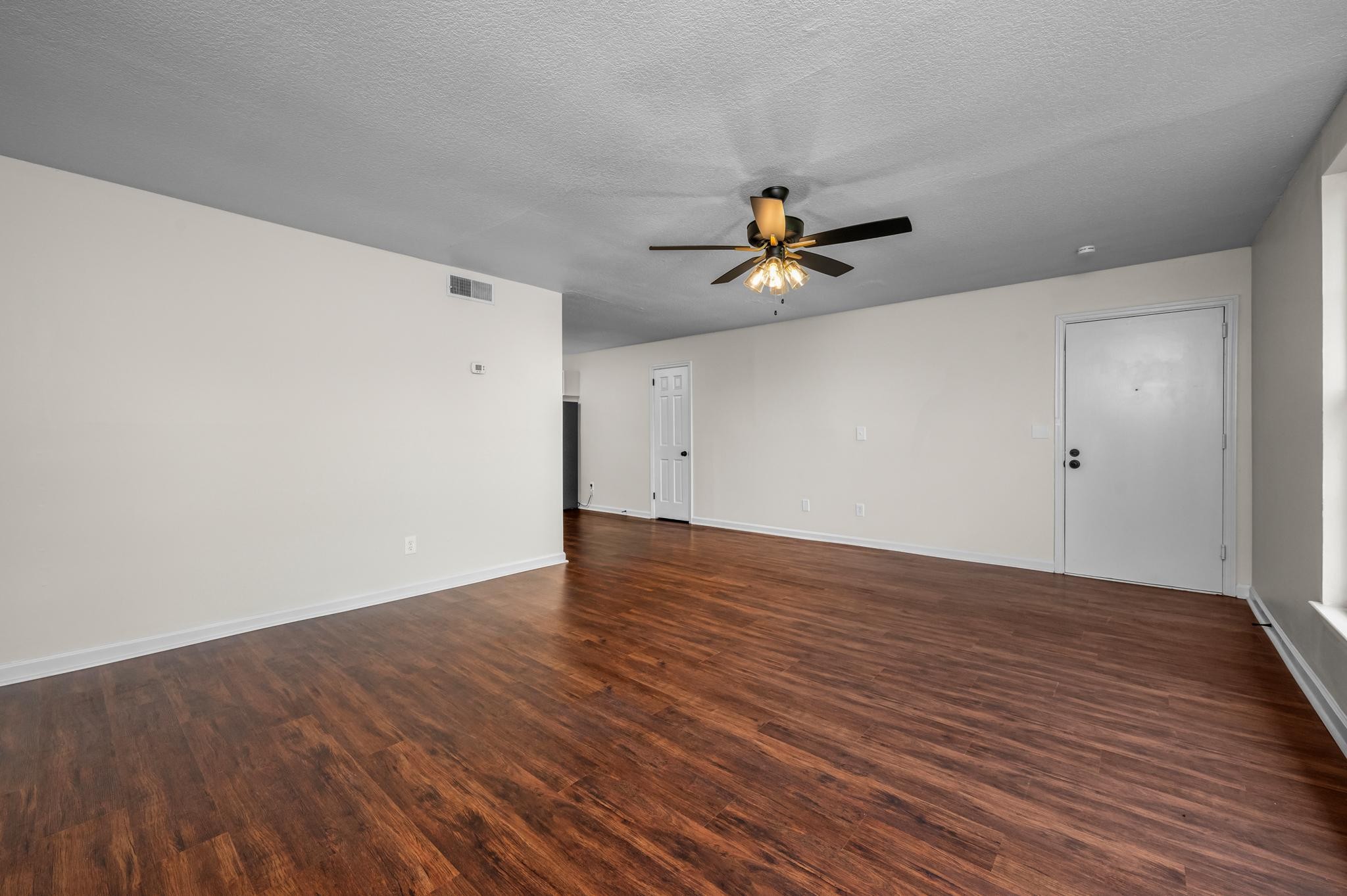 1301 Neelys Bend Road, Unit 30 Madison, TN 37115 - Photo 3 of 15 a view of a room with wooden floor and a ceiling fan