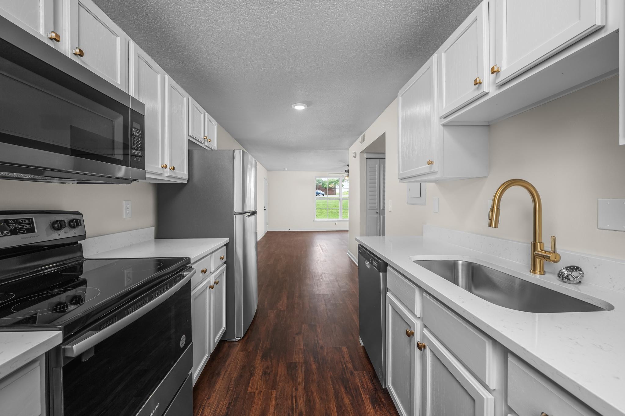 1301 Neelys Bend Road, Unit 30 Madison, TN 37115 - Photo 4 of 15 a kitchen with stainless steel appliances a sink a stove top oven a counter space and cabinets