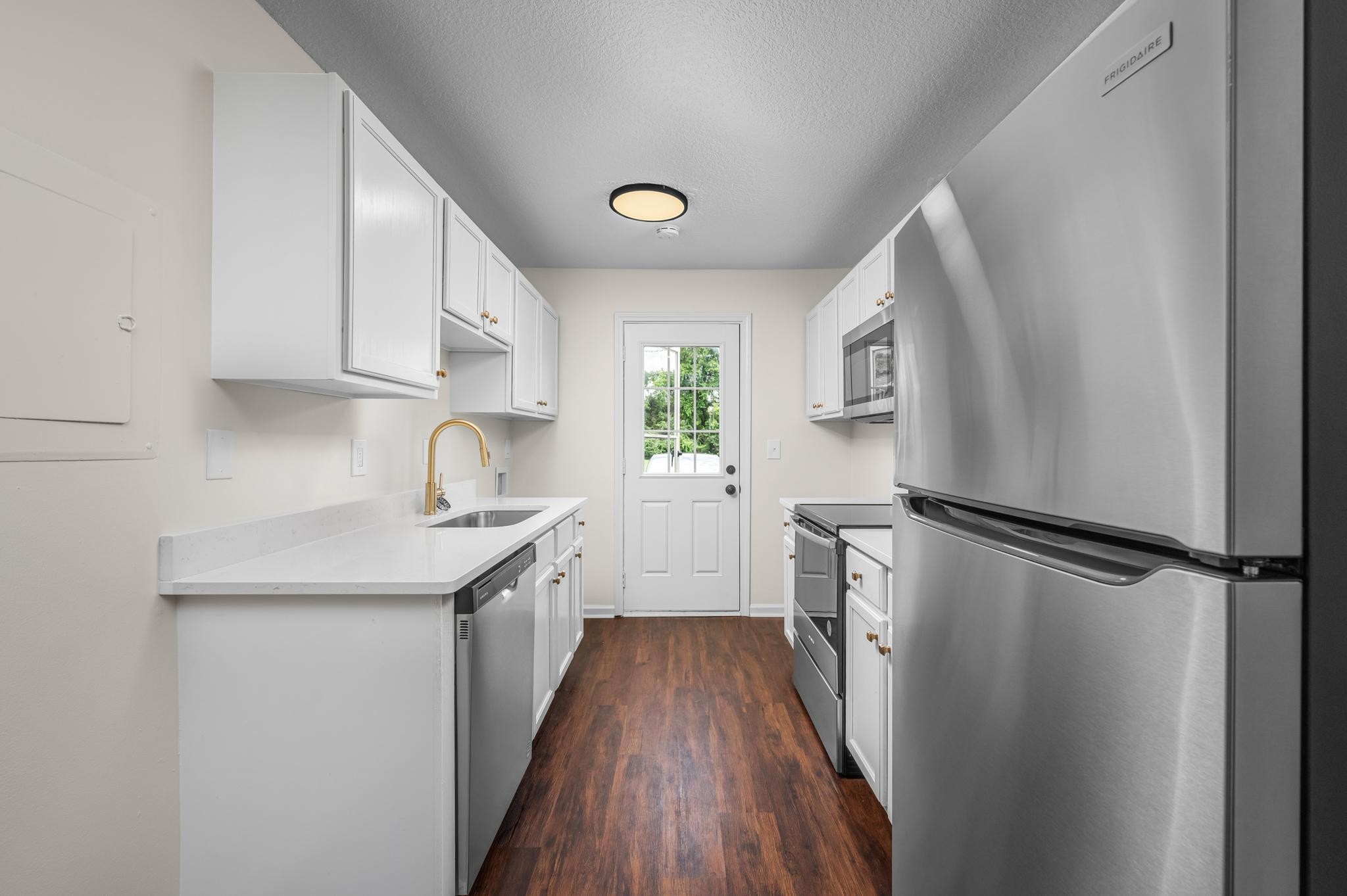 1301 Neelys Bend Road, Unit 30 Madison, TN 37115 - Photo 5 of 15 a kitchen with a sink a refrigerator and cabinets
