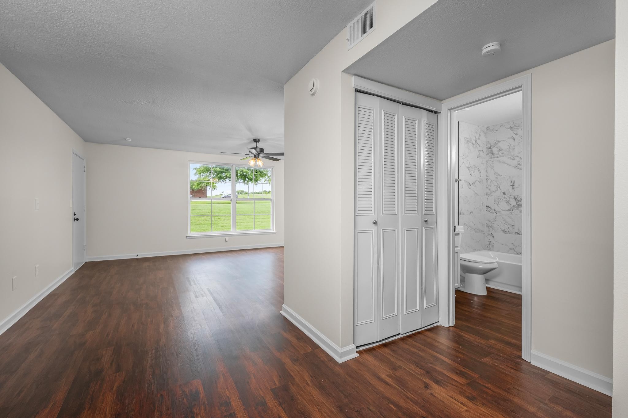1301 Neelys Bend Road, Unit 30 Madison, TN 37115 - Photo 7 of 15 a view of an empty room with wooden floor and a window