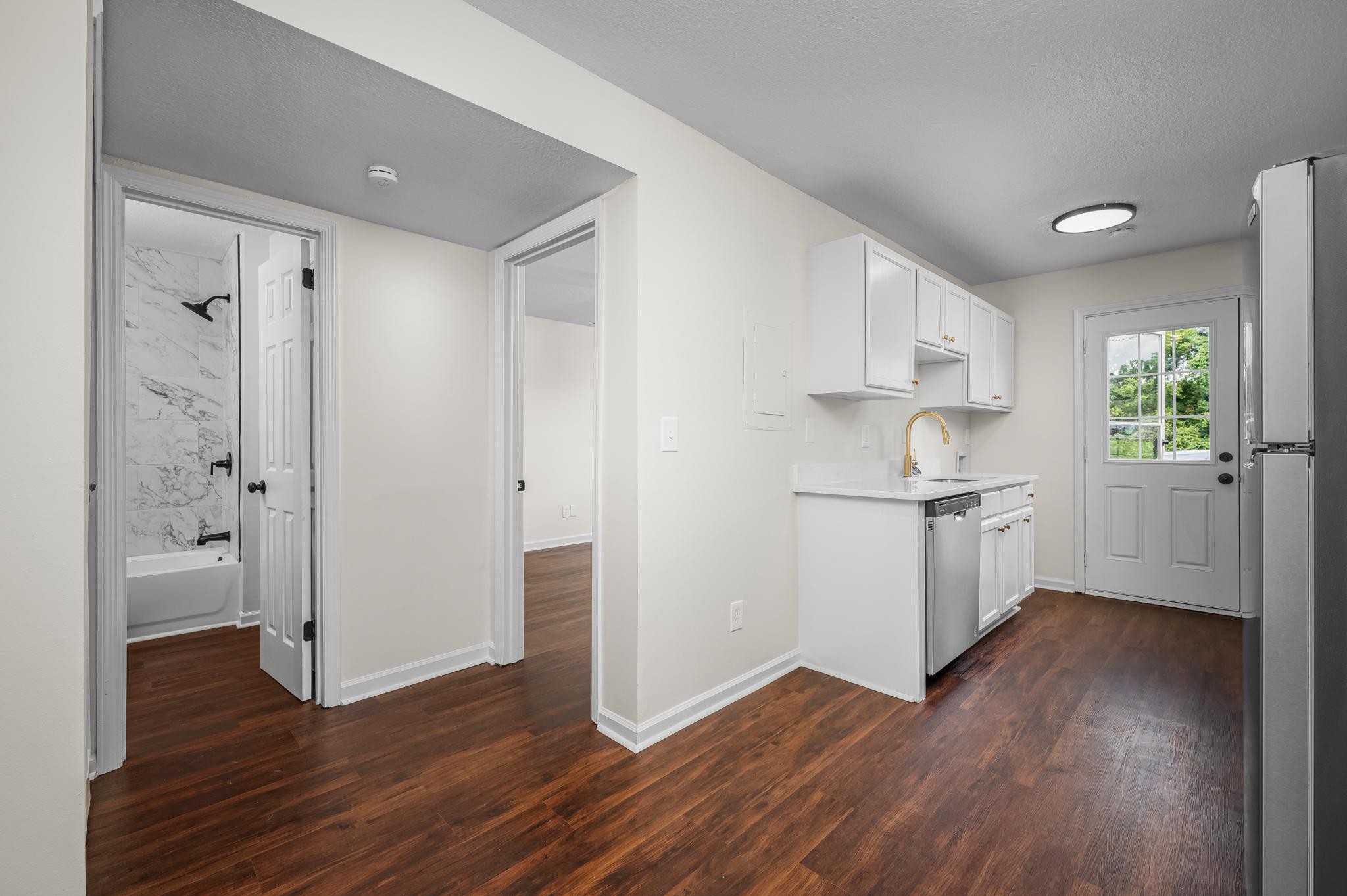 1301 Neelys Bend Road, Unit 30 Madison, TN 37115 - Photo 8 of 15 a view of a kitchen with wooden floor and a sink