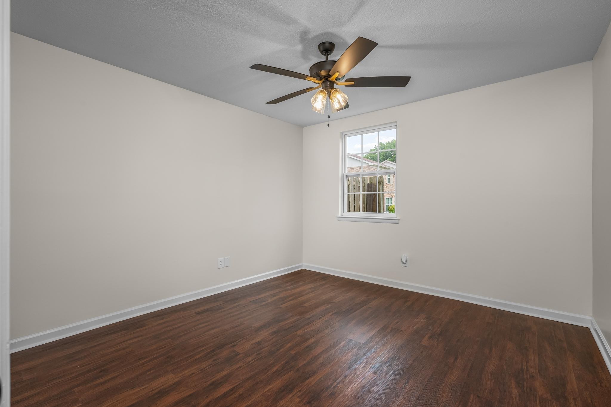 1301 Neelys Bend Road, Unit 30 Madison, TN 37115 - Photo 10 of 15 a view of a big room with wooden floor a ceiling fan and windows