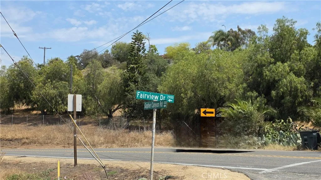 0 Fairview Vista, CA 92084 - Photo 17 of 17 a street view with tall buildings and cars parked on road