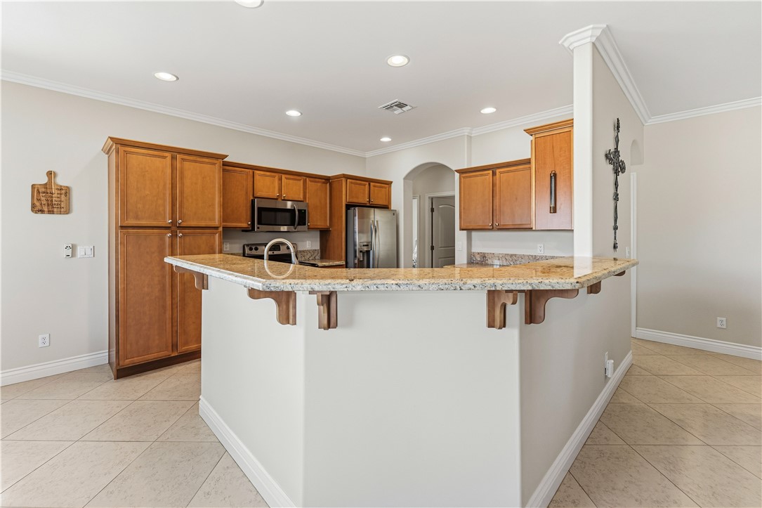 3315 Rainbow Mine Road Kingman, AZ 86401 - Photo 13 of 54 The kitchen features granite countertops, wood cabinetry, stainless steel appliances, and recessed lighting