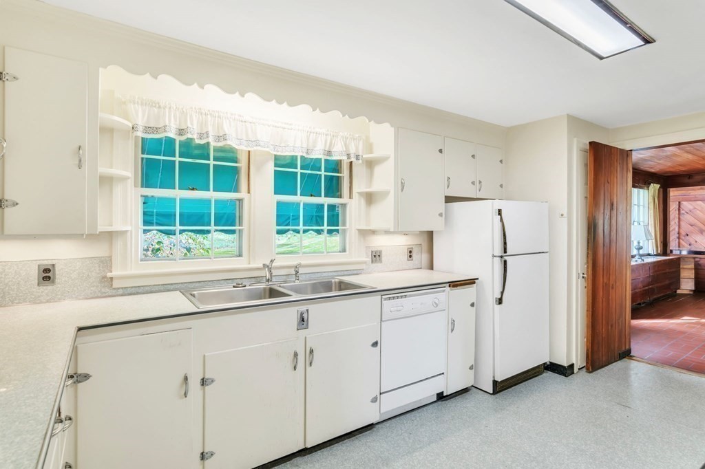 30 Green River Road Greenfield, MA 01301 - Photo 16 of 34 a kitchen with white cabinets and a window