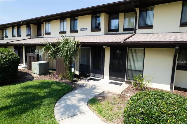 a front view of a house with a yard and porch