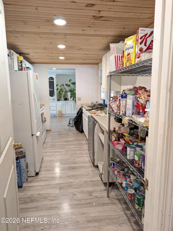a view of a storage & utility room with closet wooden floor