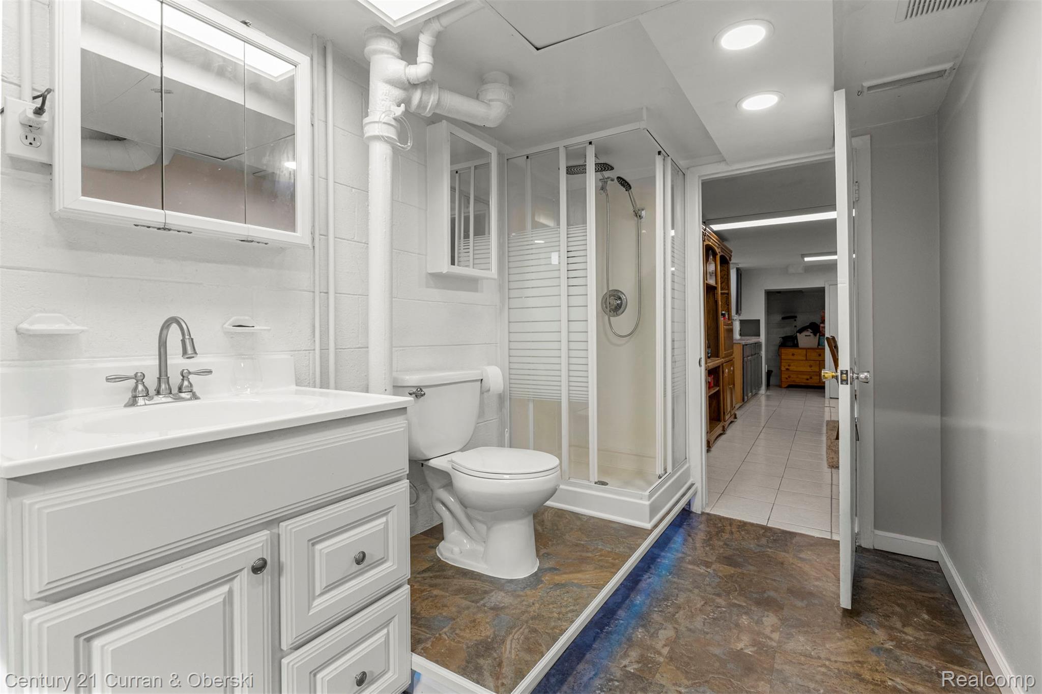 9329 Merriman Road Livonia, MI 48150 - Photo 23 of 32 Bathroom featuring vanity and a shower stall