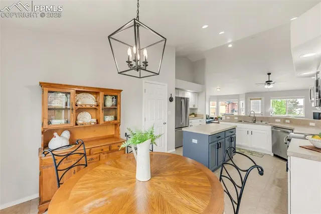 a kitchen with a table and chairs