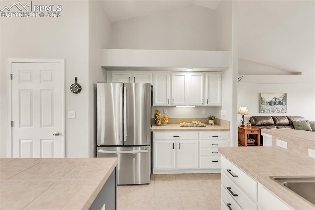 10467 Pictured Rocks Drive Peyton, CO 80831 - Photo 15 of 47 a kitchen with stainless steel appliances a refrigerator sink and cabinets