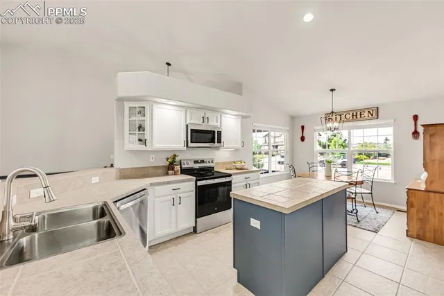 a kitchen with a sink stove and cabinets