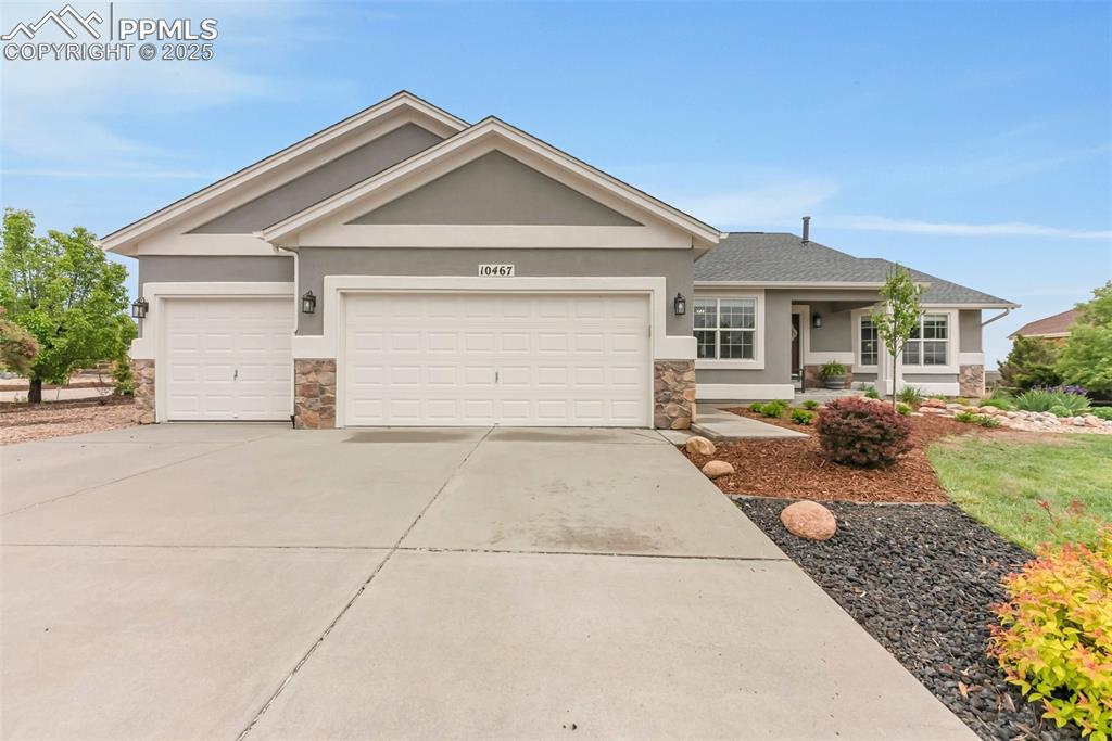 10467 Pictured Rocks Drive Peyton, CO 80831 - Photo 2 of 47 a front view of a house with a yard and potted plants