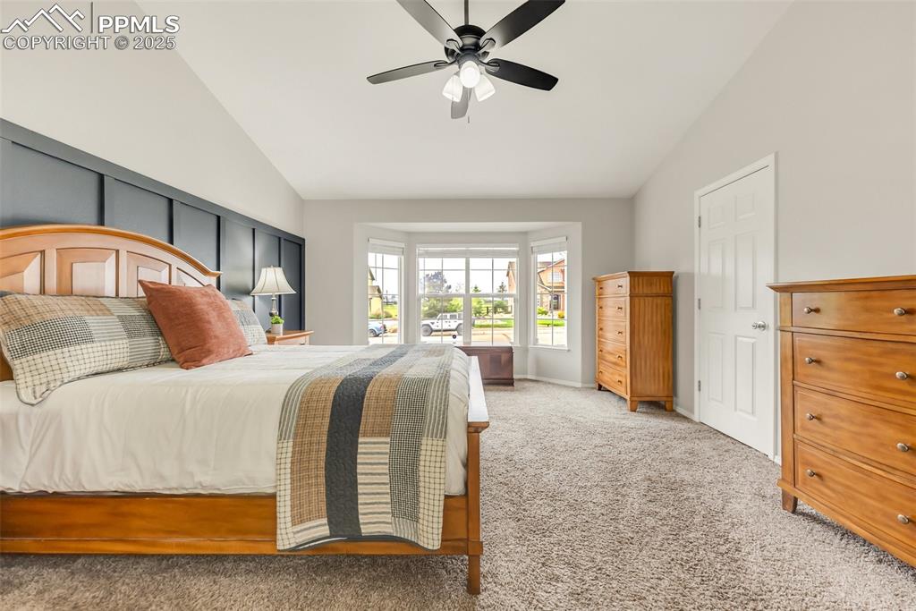 10467 Pictured Rocks Drive Peyton, CO 80831 - Photo 21 of 47 a bedroom with a large bed and a chandelier