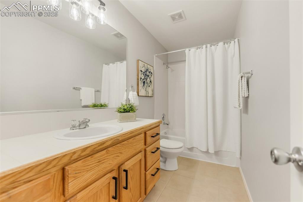 10467 Pictured Rocks Drive Peyton, CO 80831 - Photo 31 of 47 a bathroom with a granite countertop sink and a mirror
