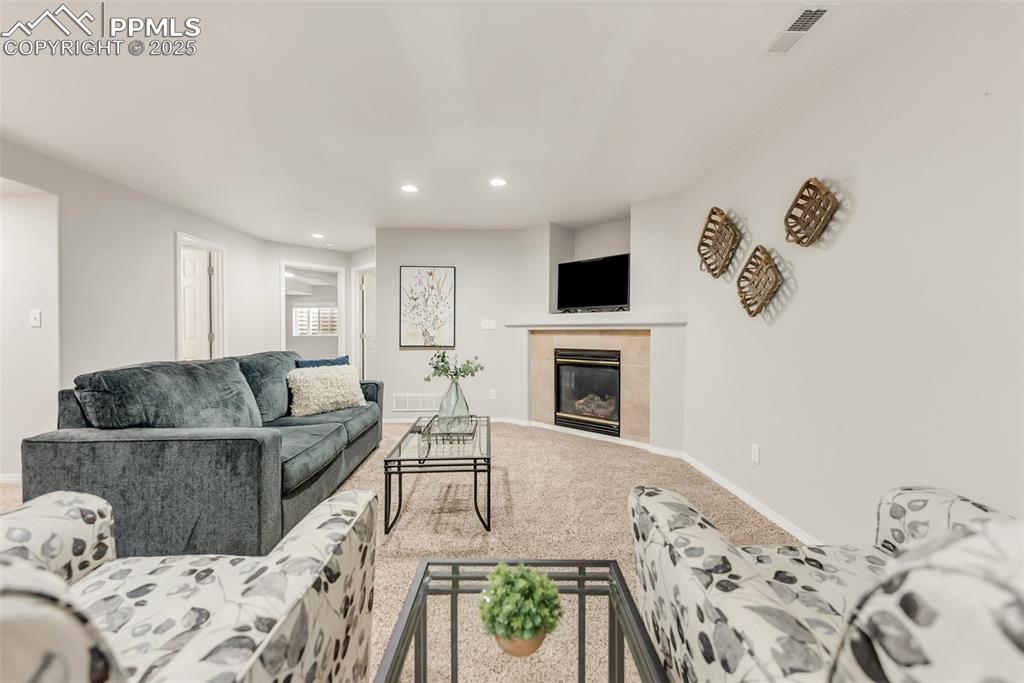 10467 Pictured Rocks Drive Peyton, CO 80831 - Photo 32 of 47 a living room with furniture and a fireplace