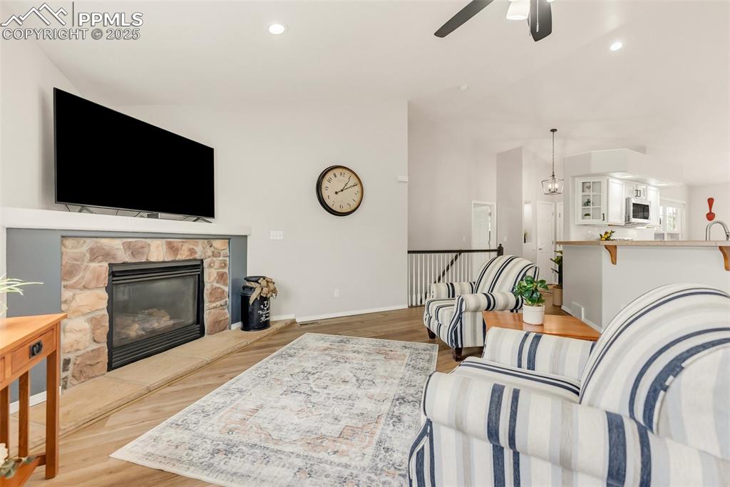 10467 Pictured Rocks Drive Peyton, CO 80831 - Photo 7 of 47 a living room with furniture a flat screen tv and a fireplace