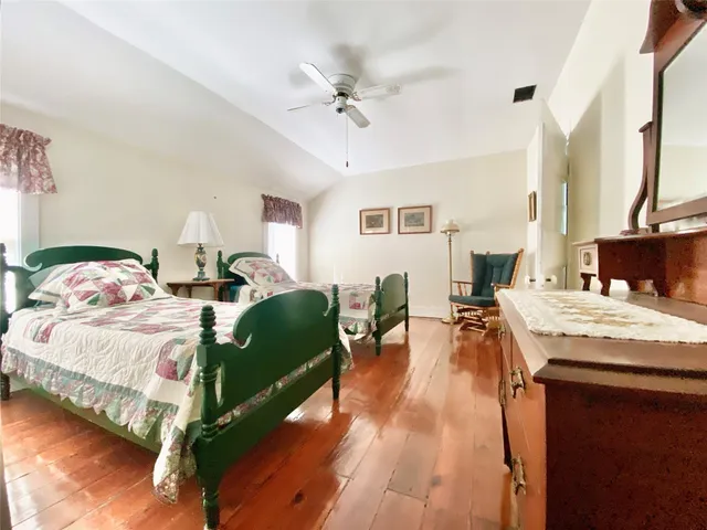 a spacious bedroom with a bed and a table in it