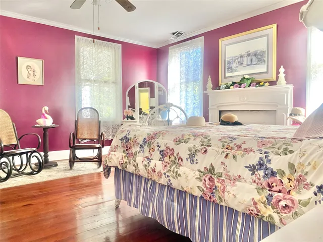 a bedroom with furniture and wooden floor
