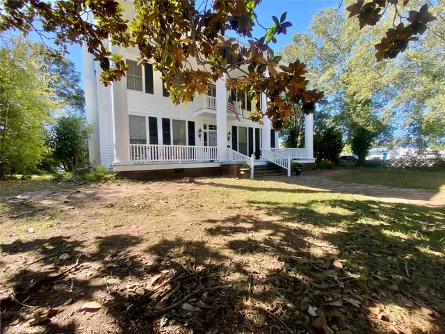 a view of a house with swimming pool and sitting area
