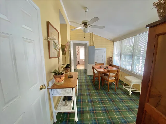 a living room with furniture a fireplace and a floor to ceiling window